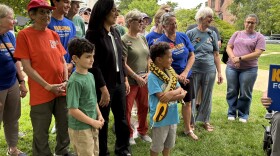 Karishma Manzur (in black) gathers with supporters at the State House, July 31, 2026.