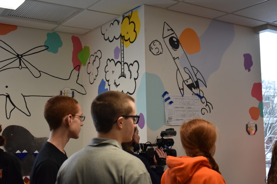 Students from Washington High School paint a mural in one of the Ronald McDonald House's playrooms.