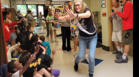 Tracy Paszotta strolls down the hallway at Littlejohn Elementary for the final time, clad in her retirement sash and crown, as kids wave goodbye.