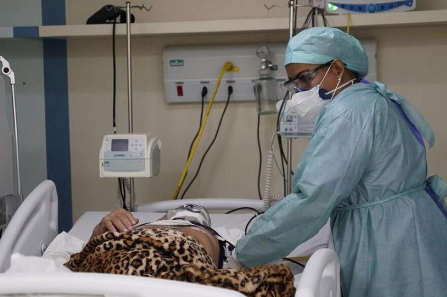 A medical worker attends to a COVID-19 patient at a hospital in Duque de Caixas, Brazil, near Rio de Janeiro this month.