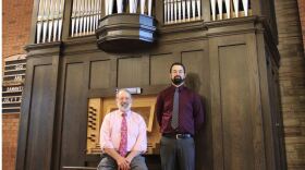 David and Nick Wallace in front of a pipe organ.