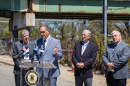 Robert Rocchio, acting director of the Rhode Island Department of Transportation, speaks near the scene of a partial bridge collapse in Cranston, as Gov. Dan McKee, Cranston Mayor Ken Hopkins and RIDOT engineer John Preiss look on.