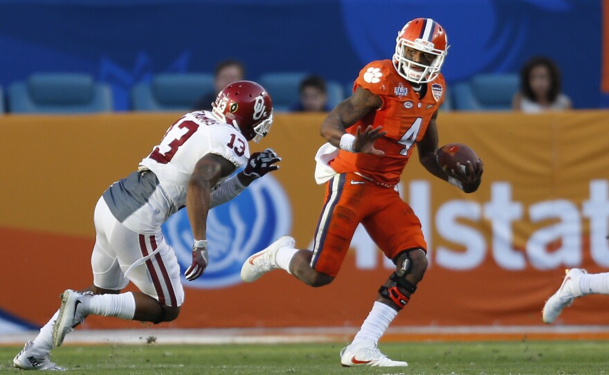 Clemson quarterback Deshaun Watson runs past Oklahoma's Ahmad Thomas during the college playoff semifinal game on New Year's Eve. Clemson won 37-17.