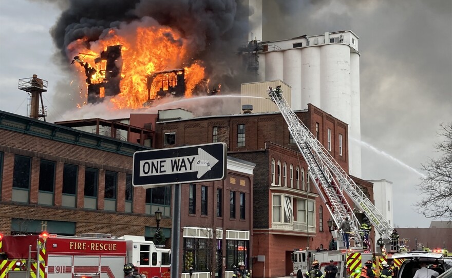 Fire and rescue vehicles including ladder trucks battle a large blaze at a former flour mill in Downtown Kent.