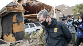 North Carolina Governor Roy Cooper surveys the damage to homes at the Ocean Ridge Plantation in Brunswick County, N.C., Wednesday, Feb. 17, 2021, after a tornado hit the area Monday night.