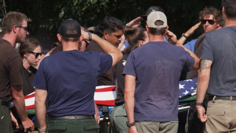 The body of a firefighter who died battling wildfires near the Colorado-Utah border is carried during a procession in Grand Junction, Colo., Monday, June 29, 2026. (AP Photo/Ty ONeil)