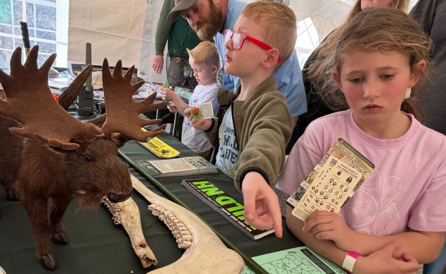Owen and Lilly Thomas of Bow saw a moose jaw bone and got a card identifying animal tracks at Discover Wild NH Day.