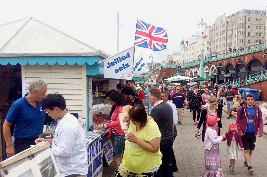 Cliff Faires (left, in blue shirt) is the owner of the Brighton Shellfish & Oyster Bar. He started selling seafood on the Brighton boardwalk as a relaxed, retirement gig 10 years ago. But Brexit is already hurting his bottom line.