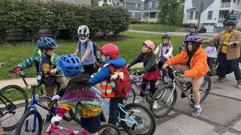 The Pleasant Ridge Bike Bus pauses on Kincaid Road as a new rider joins the group.