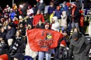A fan holds up an ISU Redbirds flag in the stands at a football game