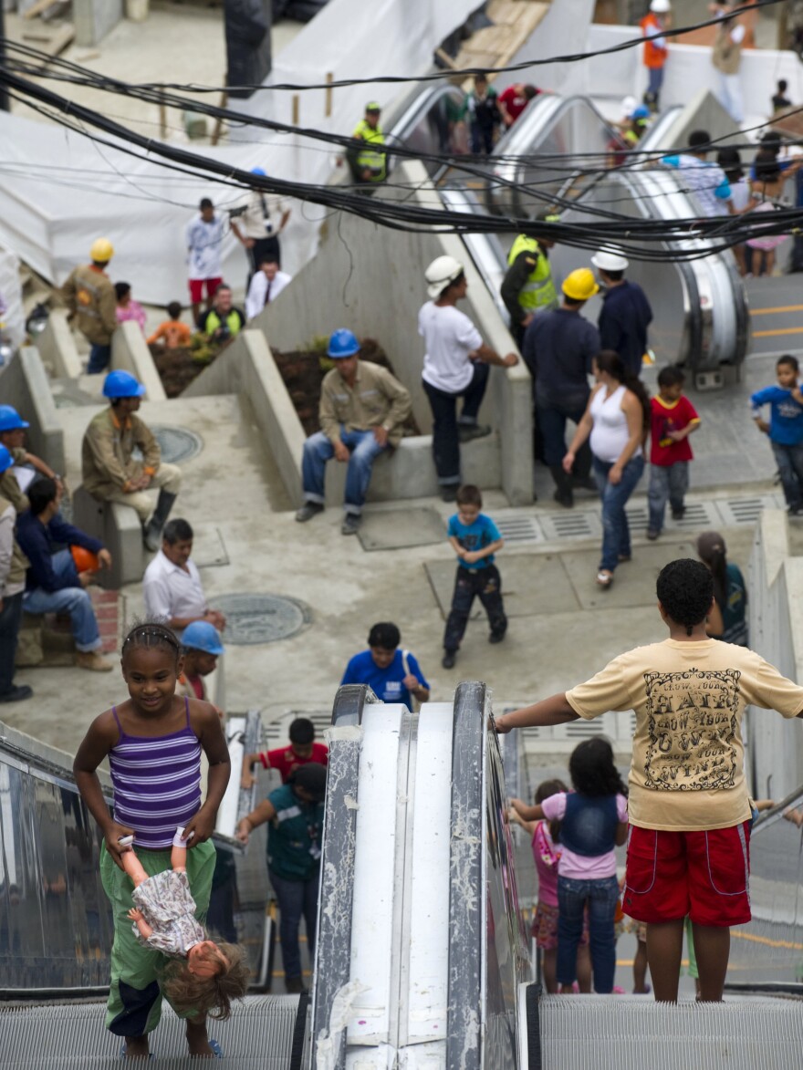 The 1,300-foot escalator linking hillside shanties with the city's commercial center is a living metaphor, linking the poor to economic opportunity.