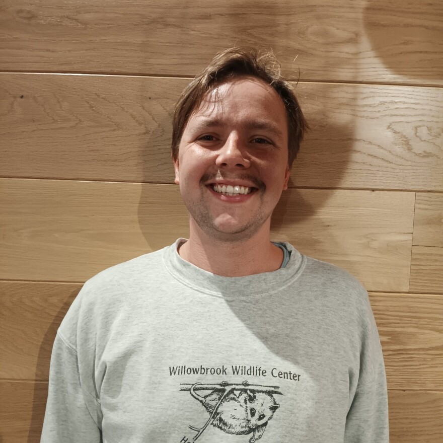 A man smiles for a portrait.