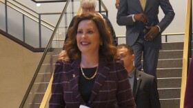 Governor Gretchen Whitmer on her way to sign a bill to boost the earned income tax credit and restore a retirement income tax break.