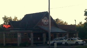 Yellow crime scene tape surrounds the 16th and Harvard Rib Crib at daybreak on Friday.