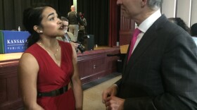 High school student Denisse Martinez speaks with attorney and mayoral candidate Steve Miller after a forum Wednesday evening at East High School. 
