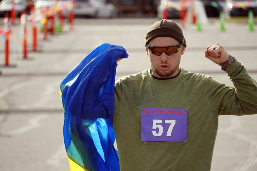 Mykola Mast carries a Ukrainian flag across the finish line of the Kenai River Marathon on Sunday, Sept. 27, 2026, at the Kenai Chamber of Commerce and Visitor Center in Kenai, Alaska.