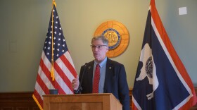 A man stands in front of a lectern.