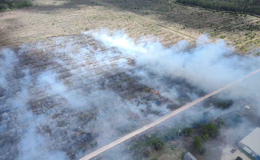 Lehigh Acres Fire Control and Rescue District working a brush fire off state Route 82 on Friday.