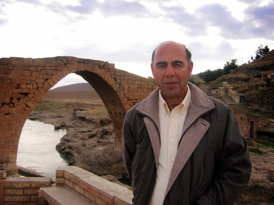 Esho Joseph stands in front of the Nemo Delale bridge in Zakho, Iraq. Joseph, a former translator, grew up speaking Aramaic.