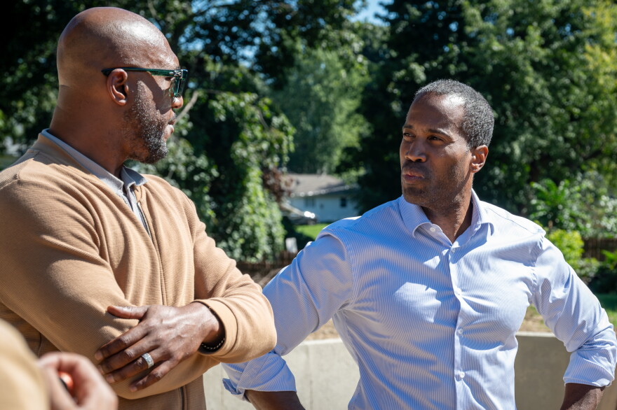Congressman John James (R-MI10) talks with Ahmad Taylor, (left) the Executive Director of the Pontiac Housing Commission.