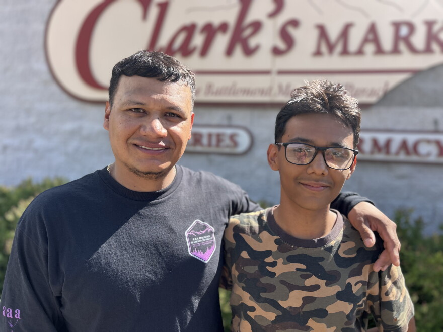 Martín Mojarro Gómez and his son, Dylan, stand outside the closed Clark’s Market in Battlement Mesa on Sept. 12, 2026.