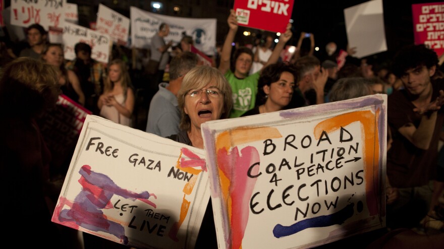 Israelis in Tel Aviv take part in a protest against the military operation in the Gaza Strip on July 26. Israel's permissive approach to free speech has long fostered protests like these, but some Israelis now say that dissenters are traitors.