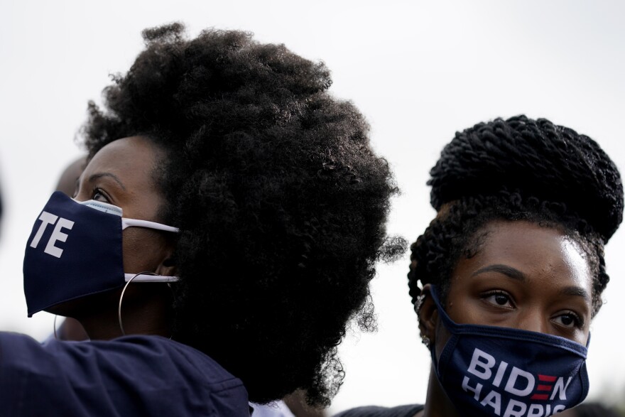 Women listen during a drive-in rally for Democratic presidential candidate former Vice President Joe Biden at Cellairis Amphitheatre in Atlanta, Tuesday, Oct. 27, 2020.