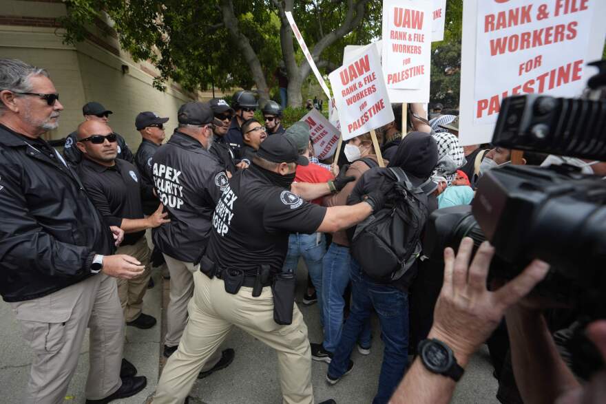 University security officers push back pro-Palestinian protesters on the campus of UCLA in Los Angeles. (Damian Dovarganes/AP)