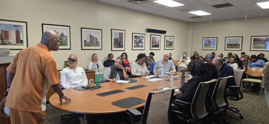 A Buffalo Municipal Housing Authority speaks before the board of commissioners at a public meeting.