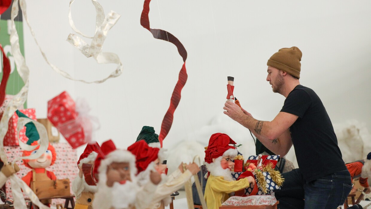 Ryan Tamer Ilgi sets up Christmas decorations that once filled the windows of Sibley's Department Store in downtown Rochester. They're being resurrected after years of sitting in storage and will be displayed at The Mercantile at Sibley Square during the holiday season.