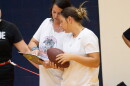 Wichita Northwest High School sophomore Avery Soetaert consults with her coach Brooke Collins during flag football practice at the school.
