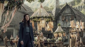 Moiraine (Rosamund Pike) visits a remote village in search of something — or someone — in Amazon's <em>The Wheel of Time</em>.