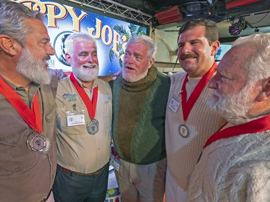 Finalists in the 2023 Hemingway Look-Alike Contest, including, from left, Paul Phillips, Tim Stockwell, Gerrit Marshall, Chris Dutton and Bat Masterson, converse on Saturday, July 22, 2023 in Key West, Fla.