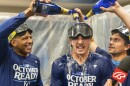 Kansas City Royals shortstop Bobby Witt Jr., center has champagne poured on him by teammates during the celebration in the locker room after a baseball game against the Atlanta Braves, Friday, Sept. 27, 2024, in Atlanta.