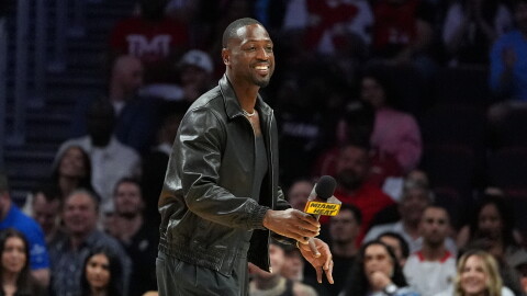 Miami Heat legend Dwyane Wade walks on the court during a time out while watching an NBA basketball game between the Miami Heat and the Dallas Mavericks, Monday, Oct. 26, 2026, in Miami.