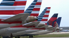 A worker on inspects multiple Republic Airways Embraer 170's on a previously vacant ramp at the Indianapolis International Airport.