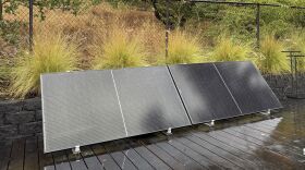 Plug-in solar panels sit on a home's outdoor deck.