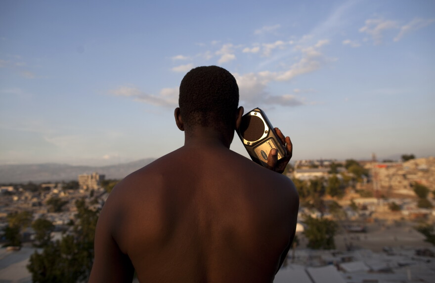 A man listens to a radio in a camp set up for people displaced by the Jan. earthquake in Port-au-Prince, Haiti, Thursday Dec. 2, 2010. (AP Photo/Guillermo Arias)