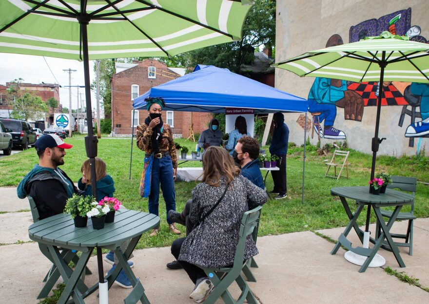 Hyde Park Market Coordinator Tiara Burtin, center, chats with a few market attendees on Saturday, May 29, 2021. The Hyde Park Market is new this year, and expects to grow through the season as more vendors get involved. It will be open at the corner of Salisbury and North 21st Streets in St. Louis every Saturday until December.