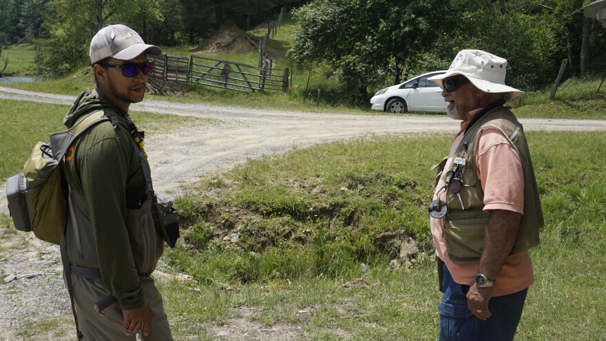 Kyle Chanitz (left) talks with fellow veteran Moir Edwards (right) on a Project Healing Waters trip to Wolf Creek in Bland County, Virginia.