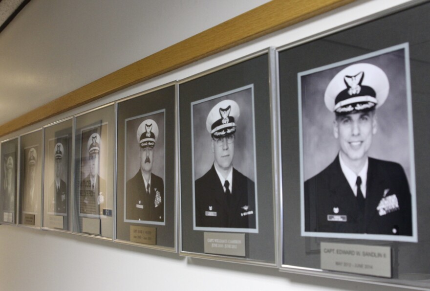 Portraits of previous Air Station Sitka Commanding Officers line the hallway to the current CO– Chip Lewin’s office (Emily Russell/KCAW)