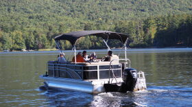 A team of researchers with the UNH Lakes Lay Monitoring Program heads out to track water quality on Lake Kanasatka in Moultonborough Thursday, Sept. 24. At the helm is lakeshore resident Kevin Kelly, who has helped measure water quality on the lake for decades. (NH Bulletin photo)