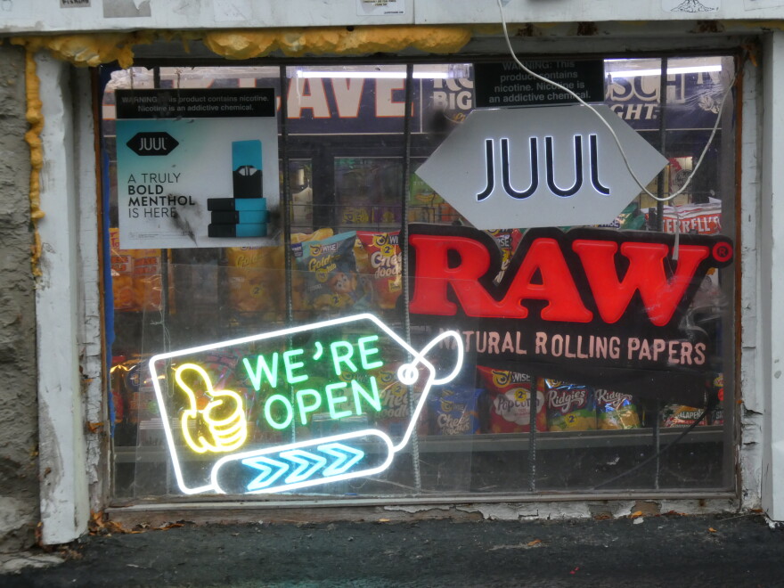 Advertisements for vapes in front of a convenience store in Syracuse.