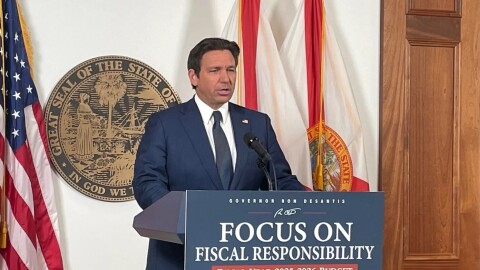 A man speaks at a podium