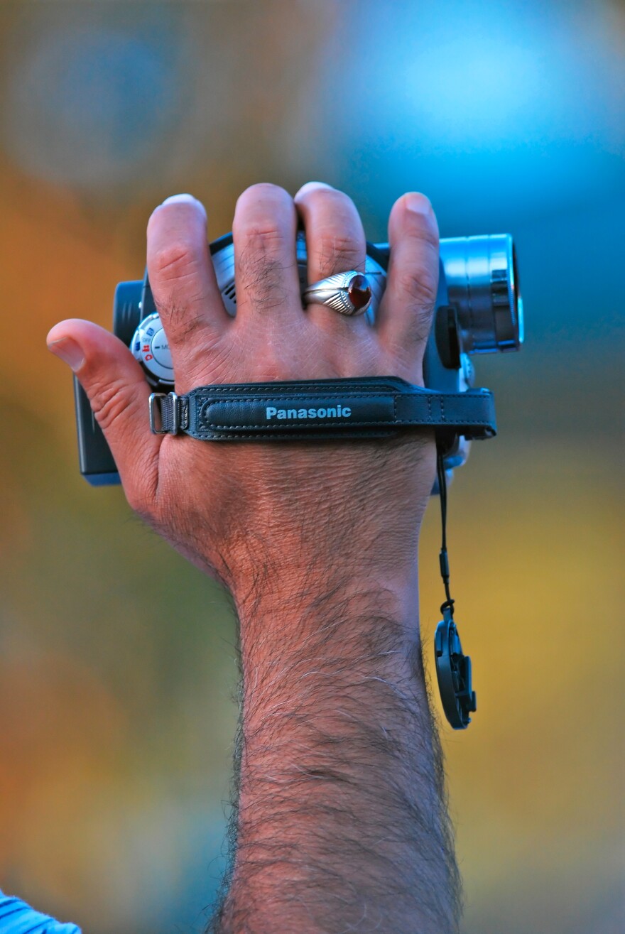 A picture of a hand holding a camcorder.