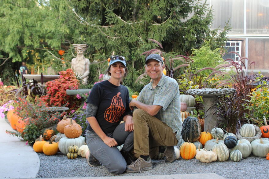 Sherri and Kevin Kukuchka, owners of Creekside Gardens, kneel in front of the entrance of the Pumpkin Walk. The annual event brings hundreds of families to Tunkhannock to see the pumpkin display.