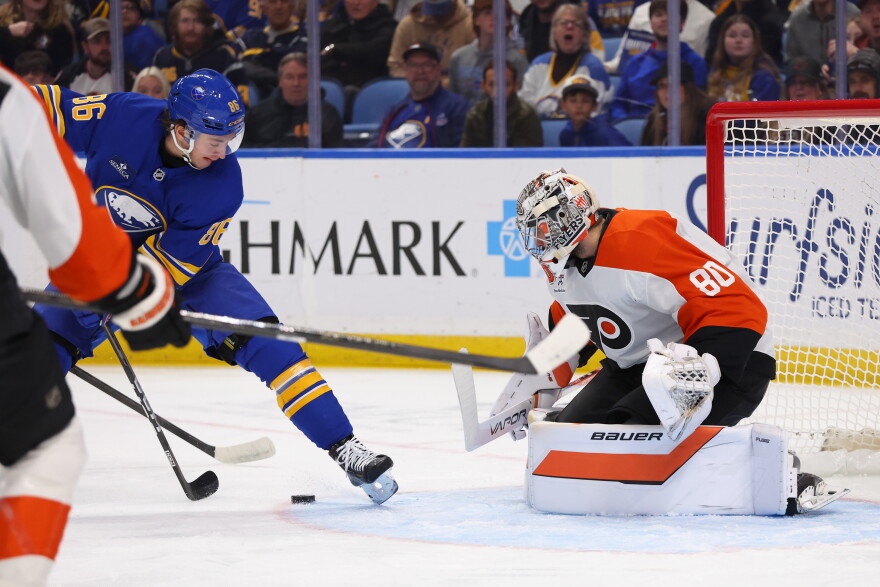 Buffalo Sabres right wing Jack Quinn (22) is stopped by Philadelphia Flyers goaltender Dan Vladar (80) during the first period of an NHL hockey game Wednesday, Oct. 21, 2026, in Buffalo, N.Y. (AP Photo/Jeffrey T. Barnes)