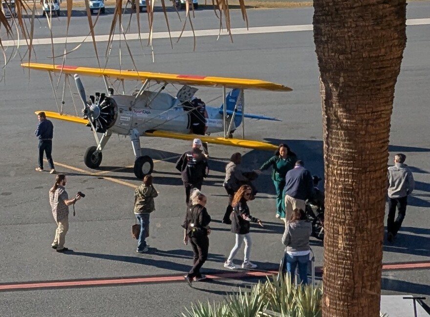 The first contingent of Dream Flight veterans gather on the airport tarmac in preparation for boarding the biplane.
