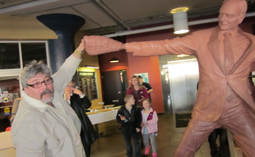 Sculptor William Koch with clay figure of Griffin statue