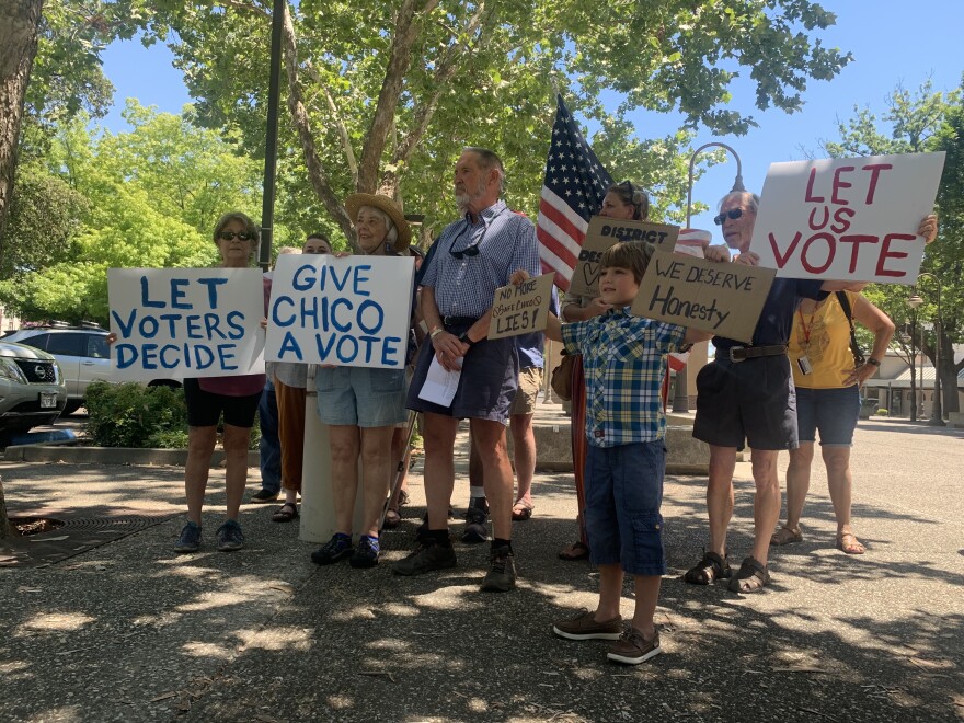 David Welch, secretary of the Butte County Democratic Party, center, is flanked by supporters calling for a special election to fill two vacant seats on the Chico City Council.